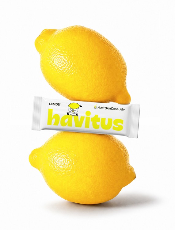Two lemons stacked with a Havitus lemon collagen jelly stick between them